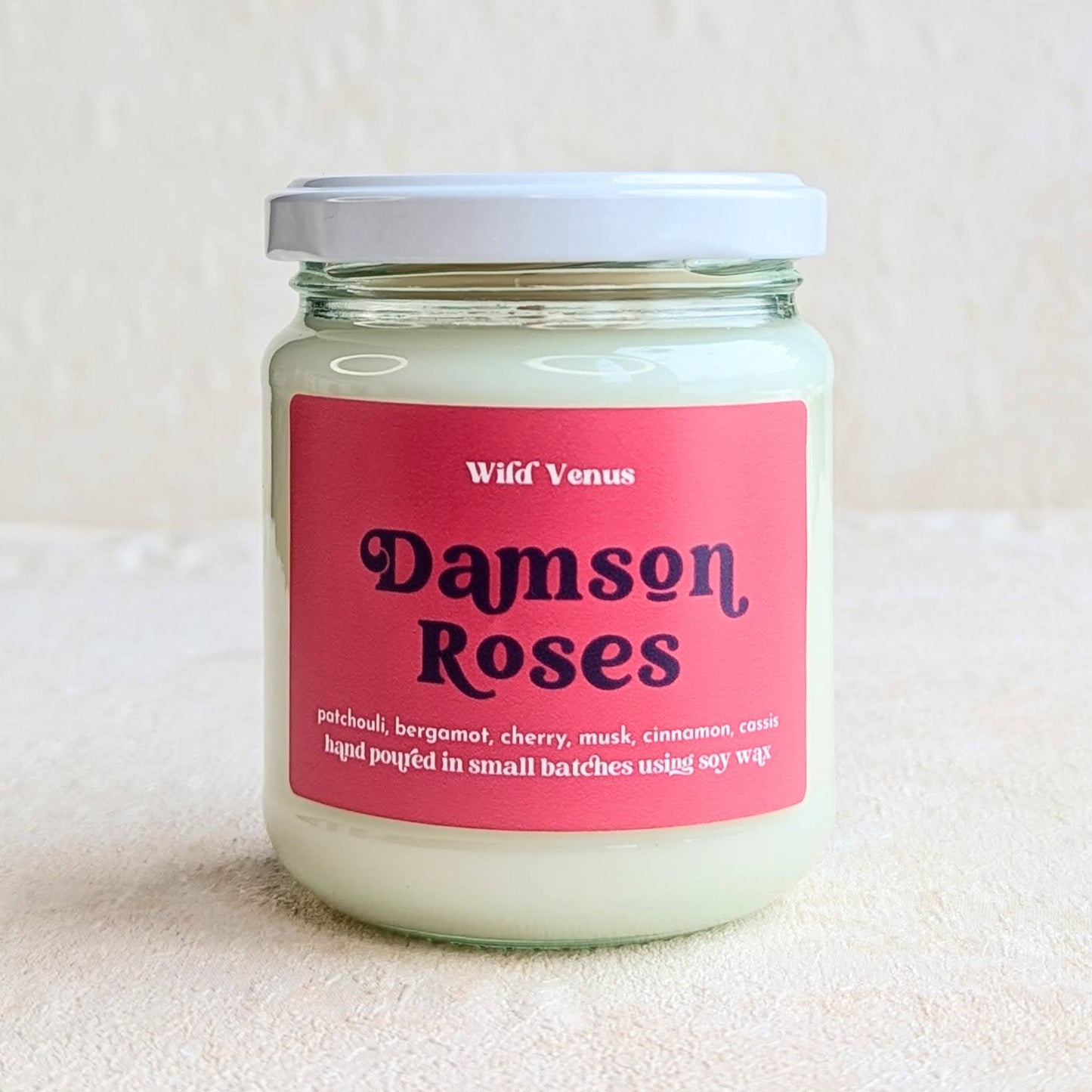 Damson roses soy candle on a white background.