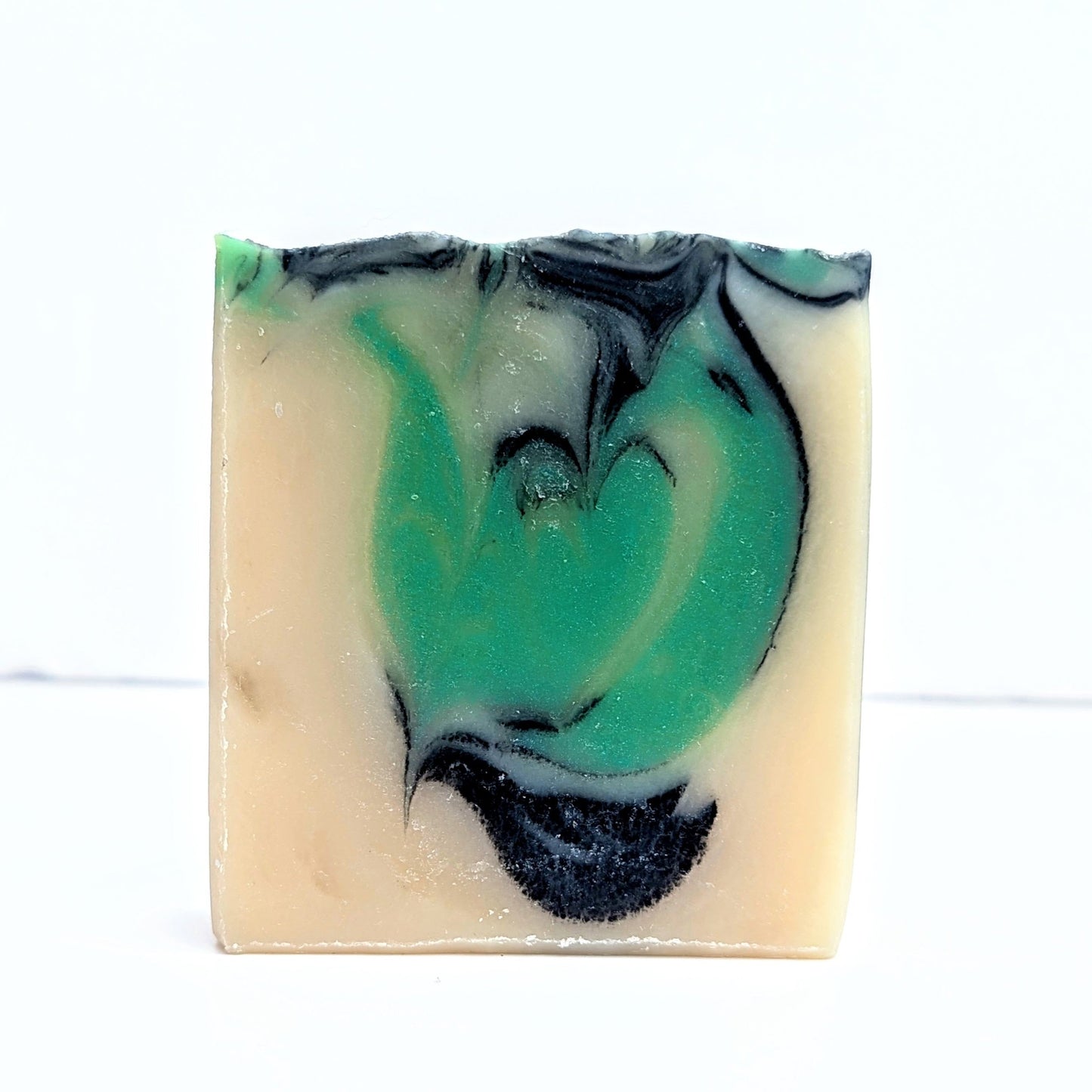 A bar of enchanted forest vegan soap without a label on.