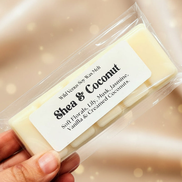 Shea & Coconut wax melt in clear packaging held by a hand on a light background
