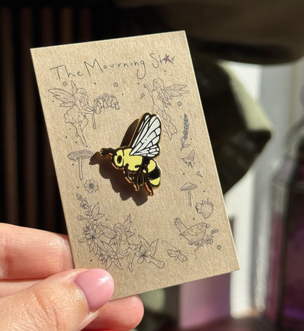 The Mourning Star Bee enamel pin