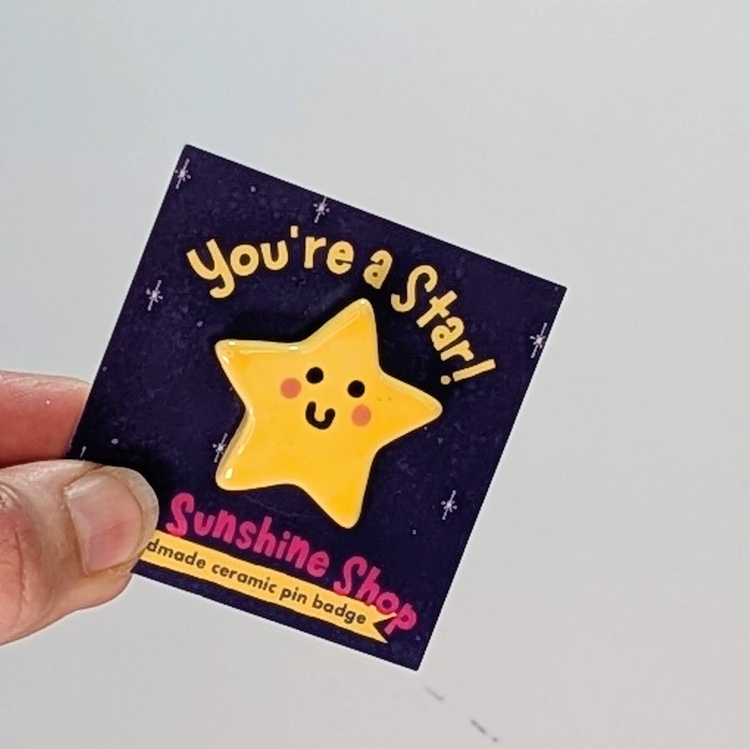 A ceramic pin badge which says "You're a Star" on the packaging.