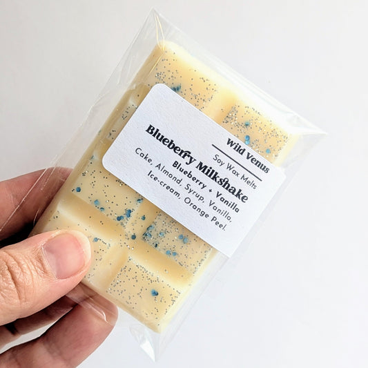 A Blueberry Milkshake soy wax melt is pretty with blue and silver glitter. 