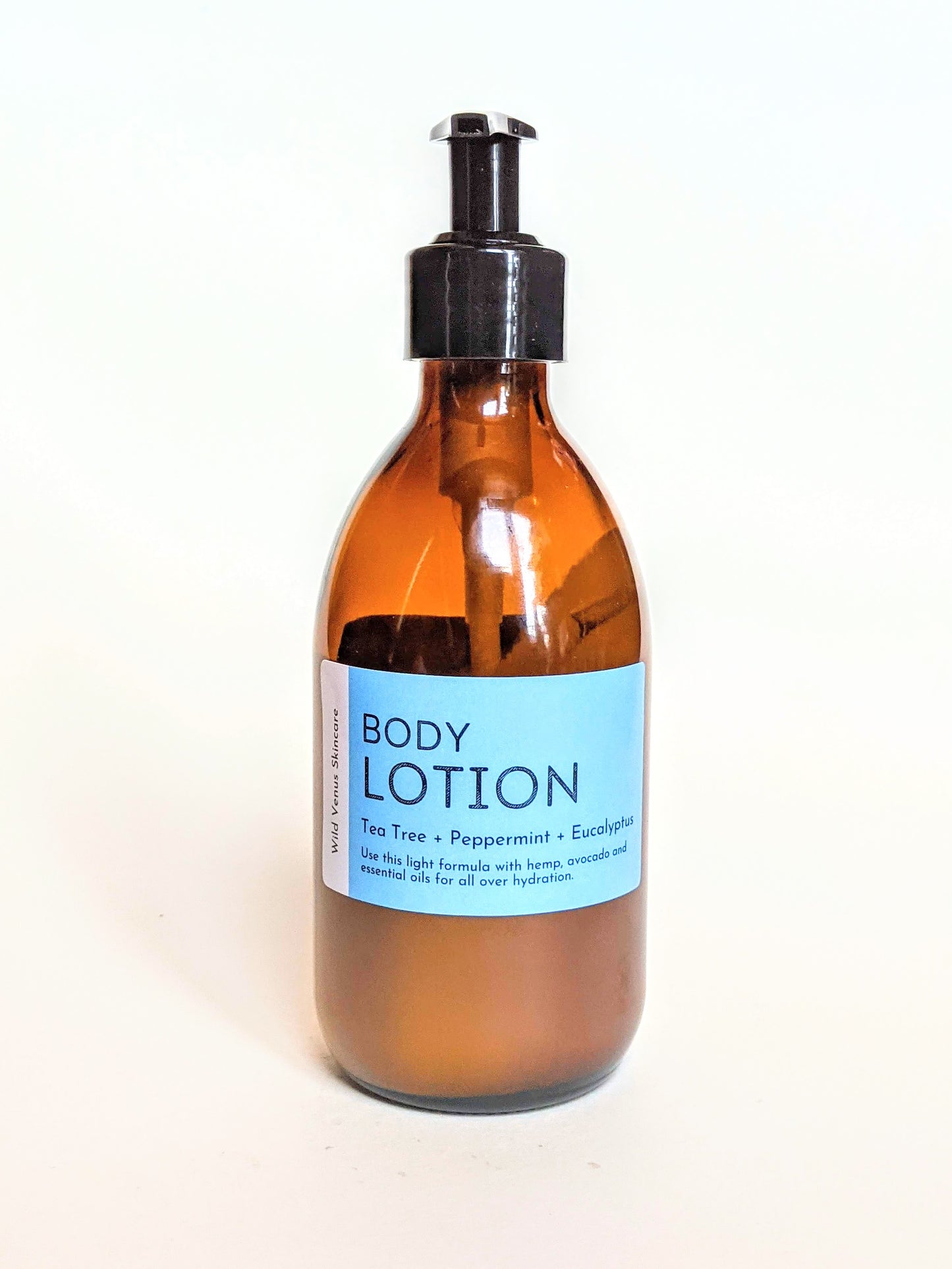 An amber bottle with tea tree, peppermint and eucalyptus essential oil scented hand and body lotion. 