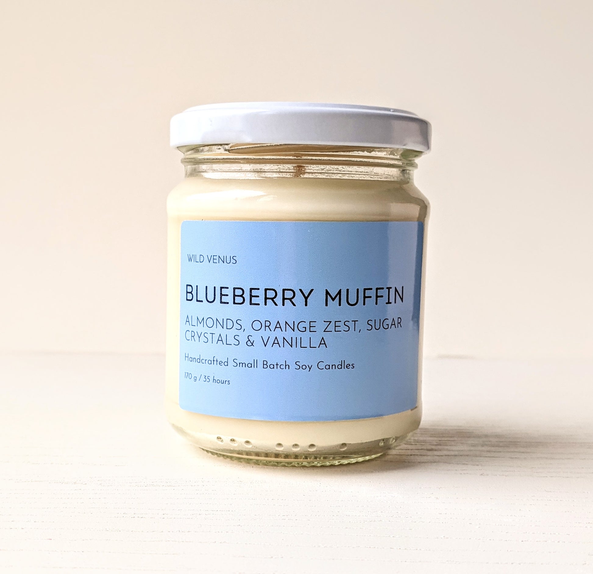 A blueberry muffin scented candle against a white background.