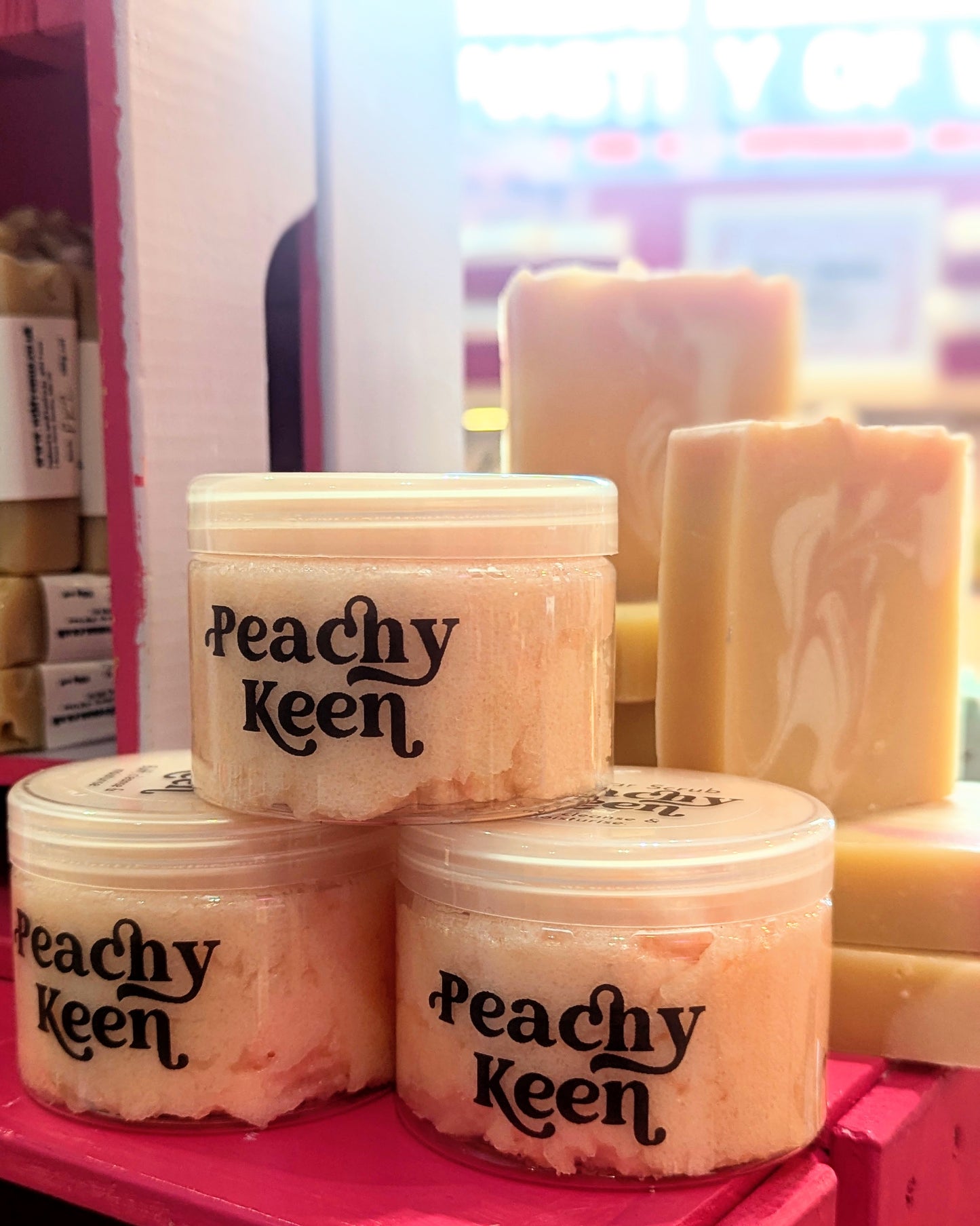 Display of peachy keen sugar scrubs and soaps. 