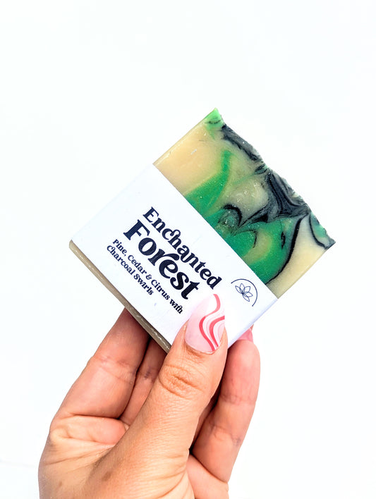 Holding a bar of enchanted forest soap against a white background. 