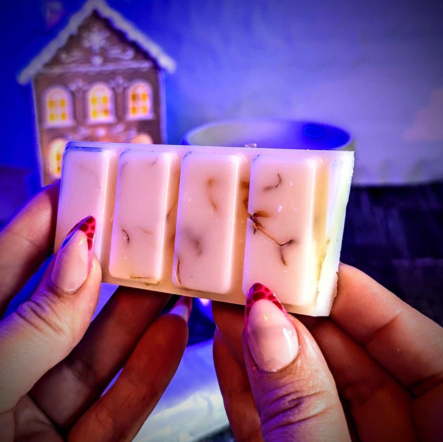 Holding an unwrapped Gingerbread scented soy wax melt. 