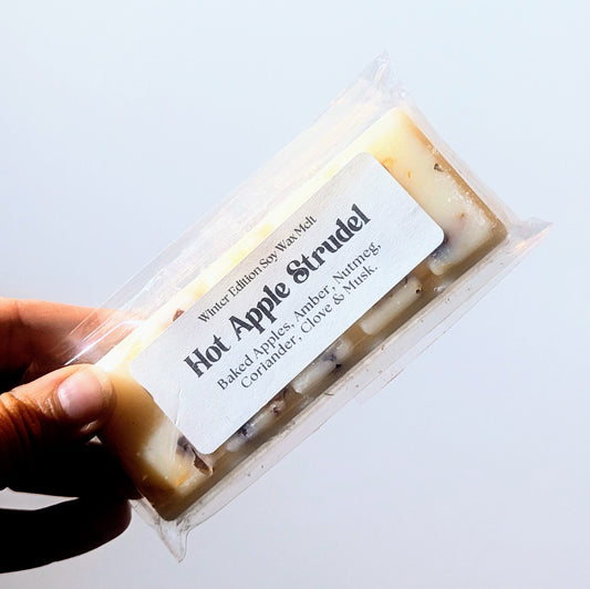 Holding the hot apple strudel soy wax melt against a white background.