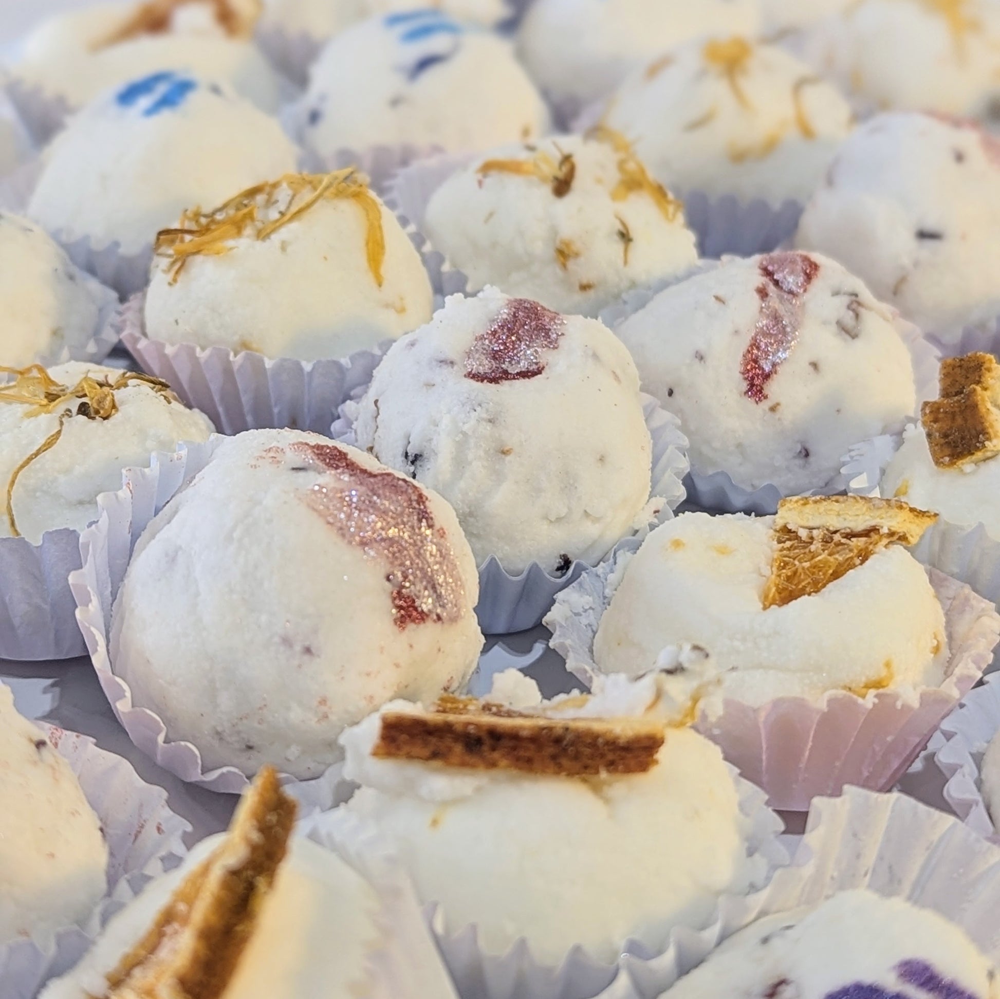 A close up of mango butter bath bombs.