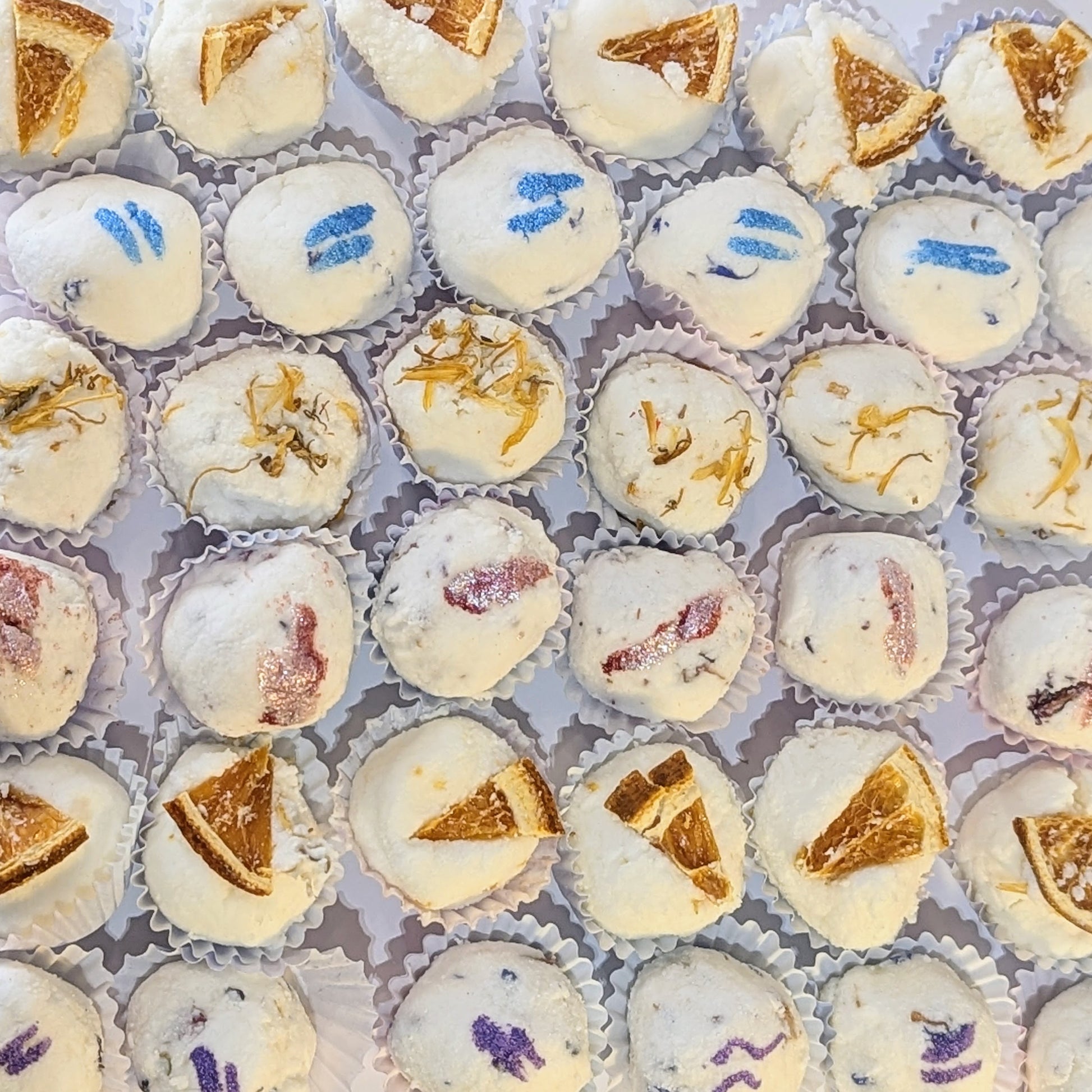 A photo of various mango butter bath bombs from above.