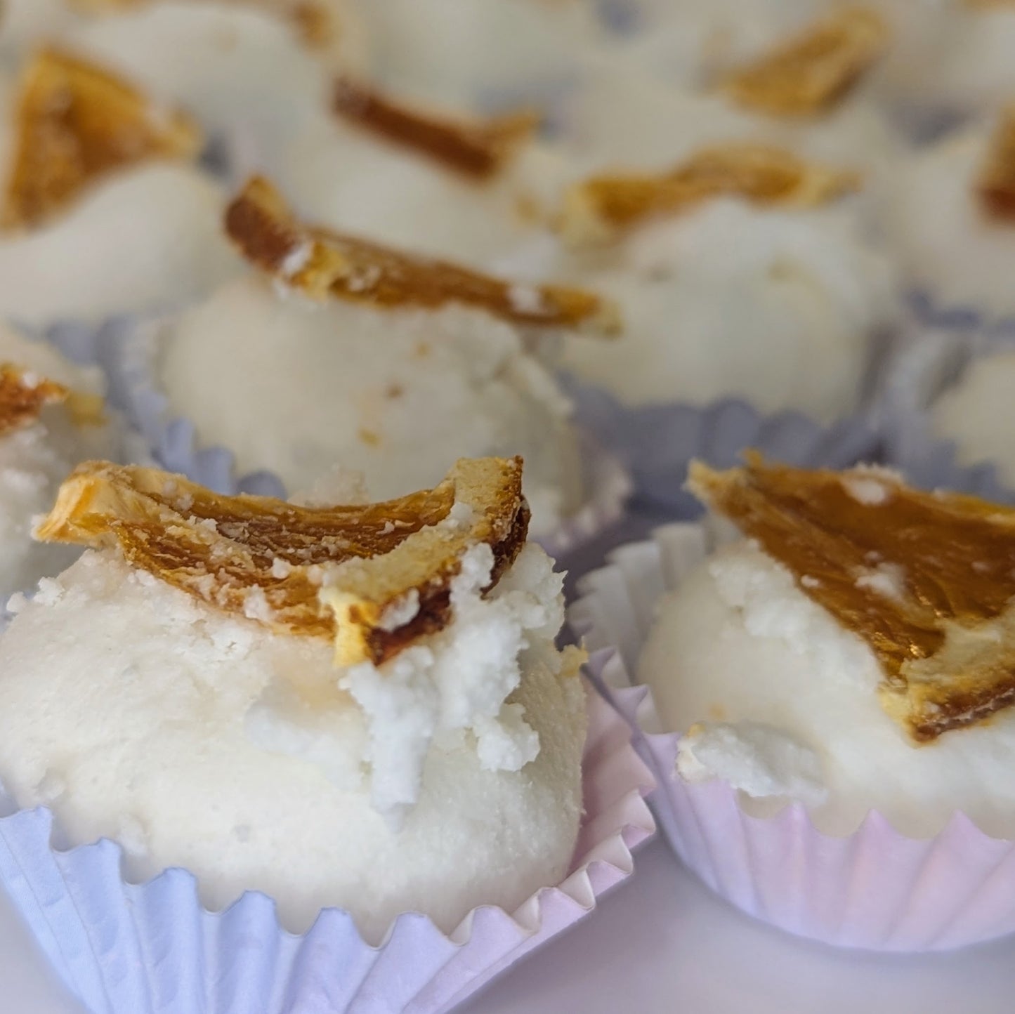 A close up of the spiced orange mango butter bath bombs.