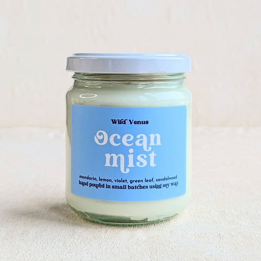 An Ocean Mist scented soy candle is against a plain white background. 