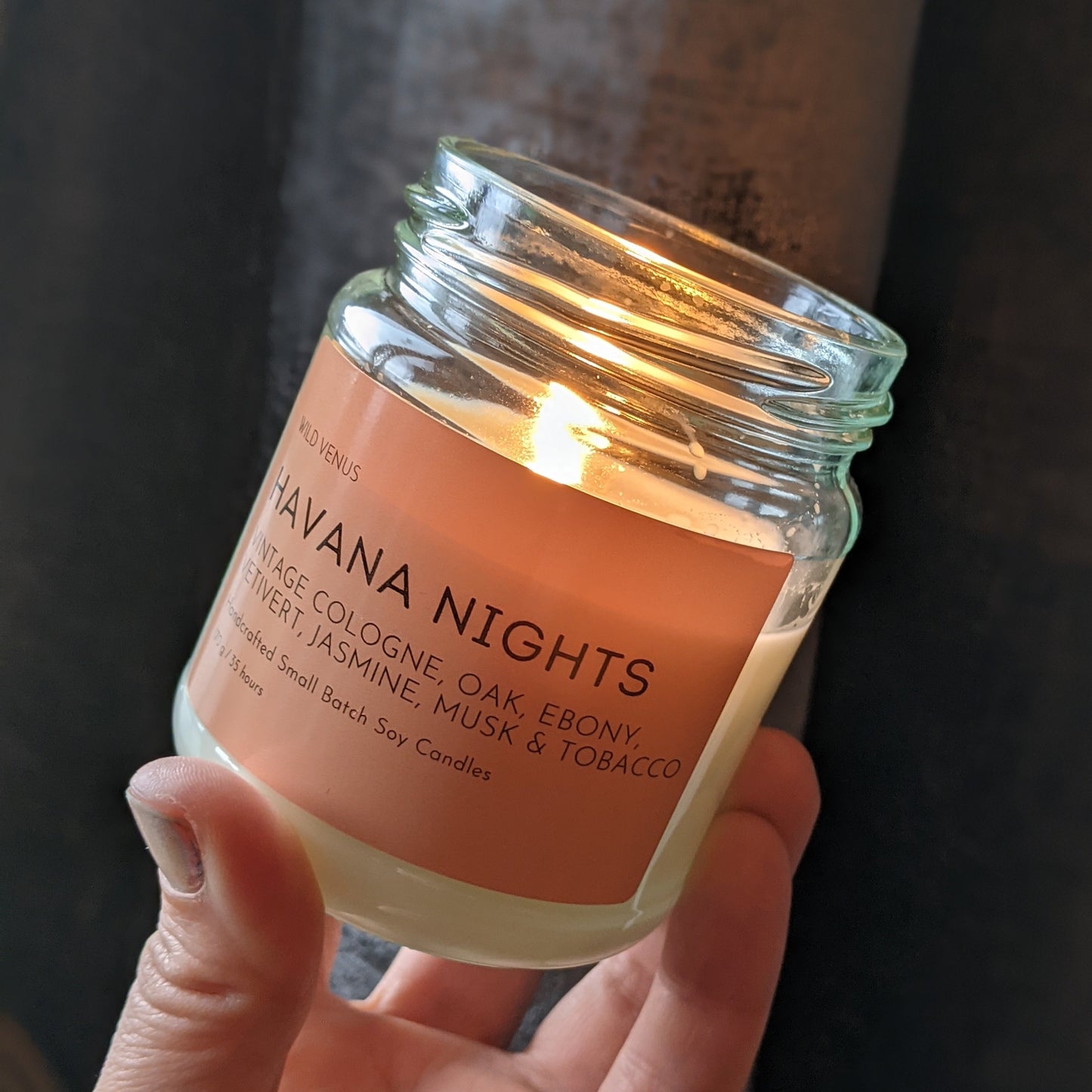 Holding a candle called 'Havana Nights'