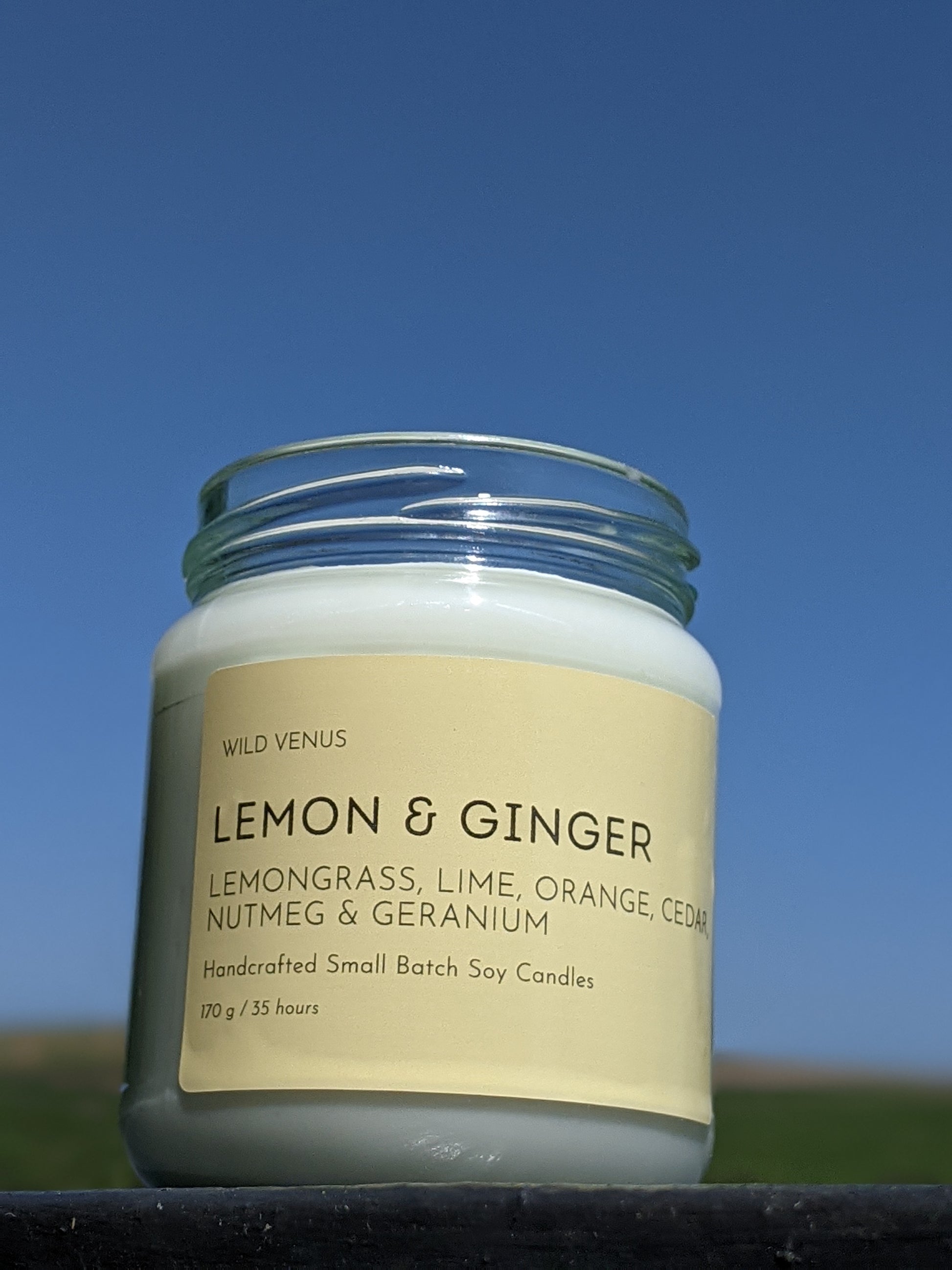 A jar of lemon and ginger scented soy candle. 