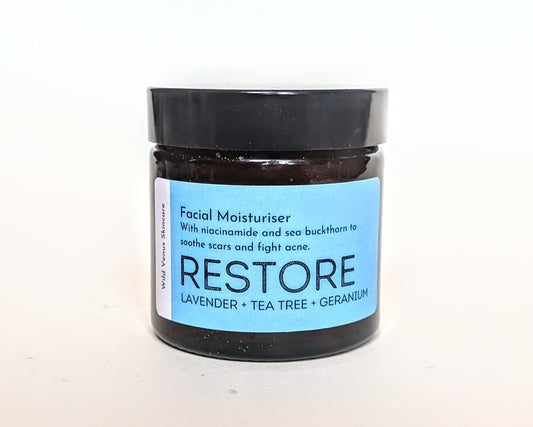A closed jar of RESTORE facial moisturiser. 