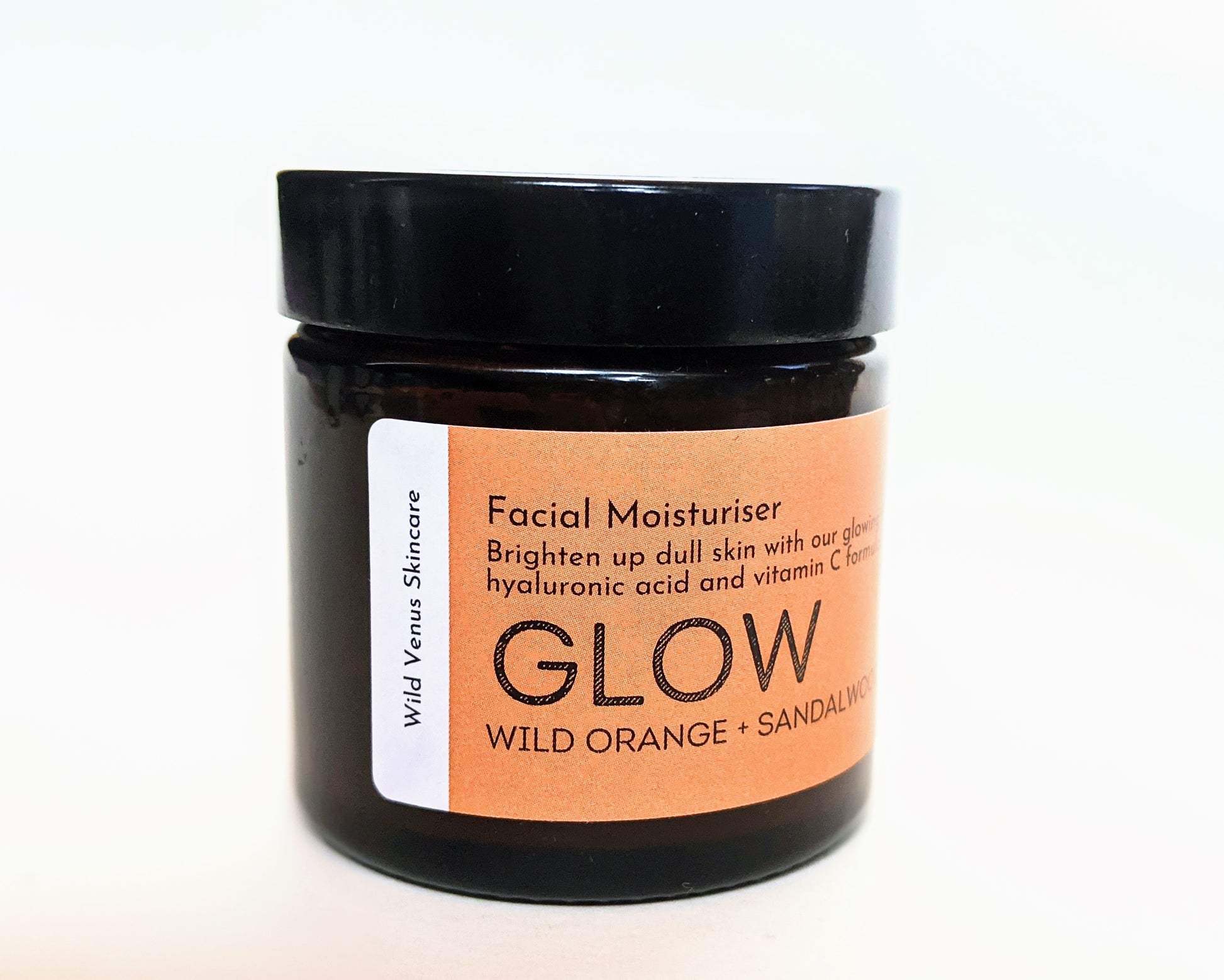 A closed jar of the GLOW facial moisturiser, shown from a side angle. 