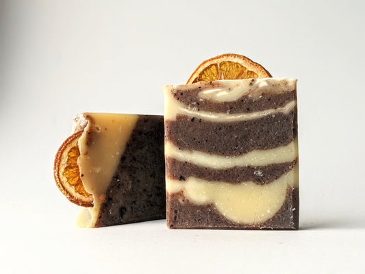 Two bars of the Winter Spice soap with oranges embedded in the tops. 