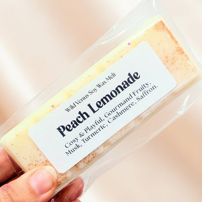 Peach lemonade wax melt against a peach background. 