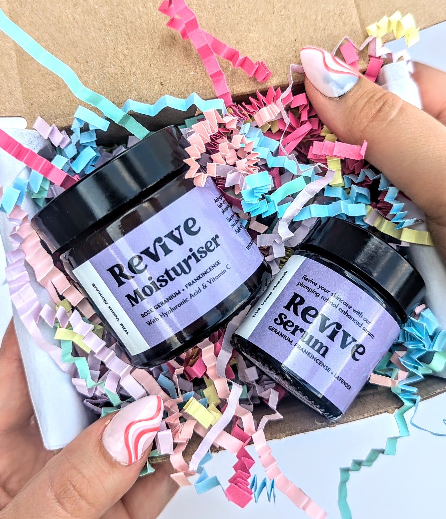 Holding a Revive SKincare Duo Gift Box