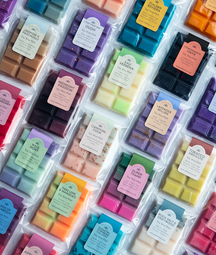A flat lay view of lots of colourful soy wax melts. 