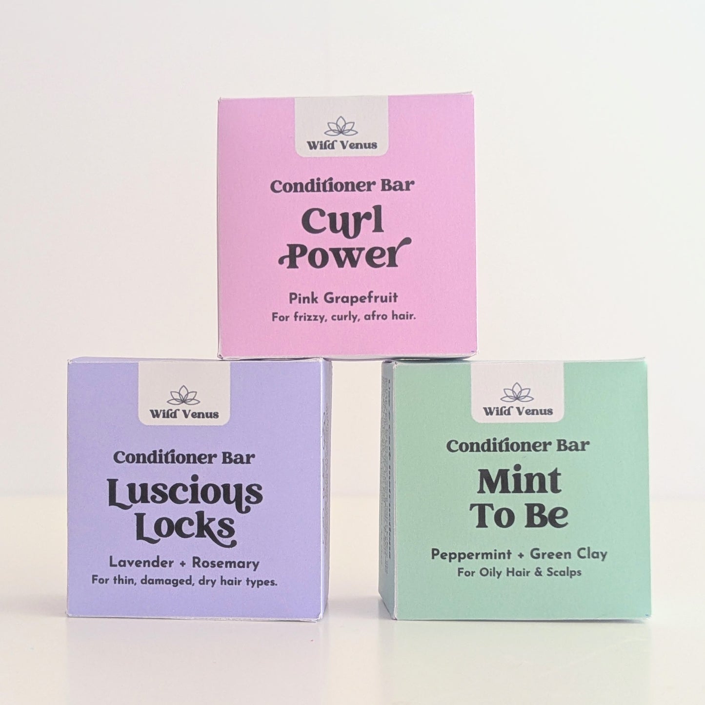 3 solid conditioner bar boxes on top of each other in a pyramid shape.