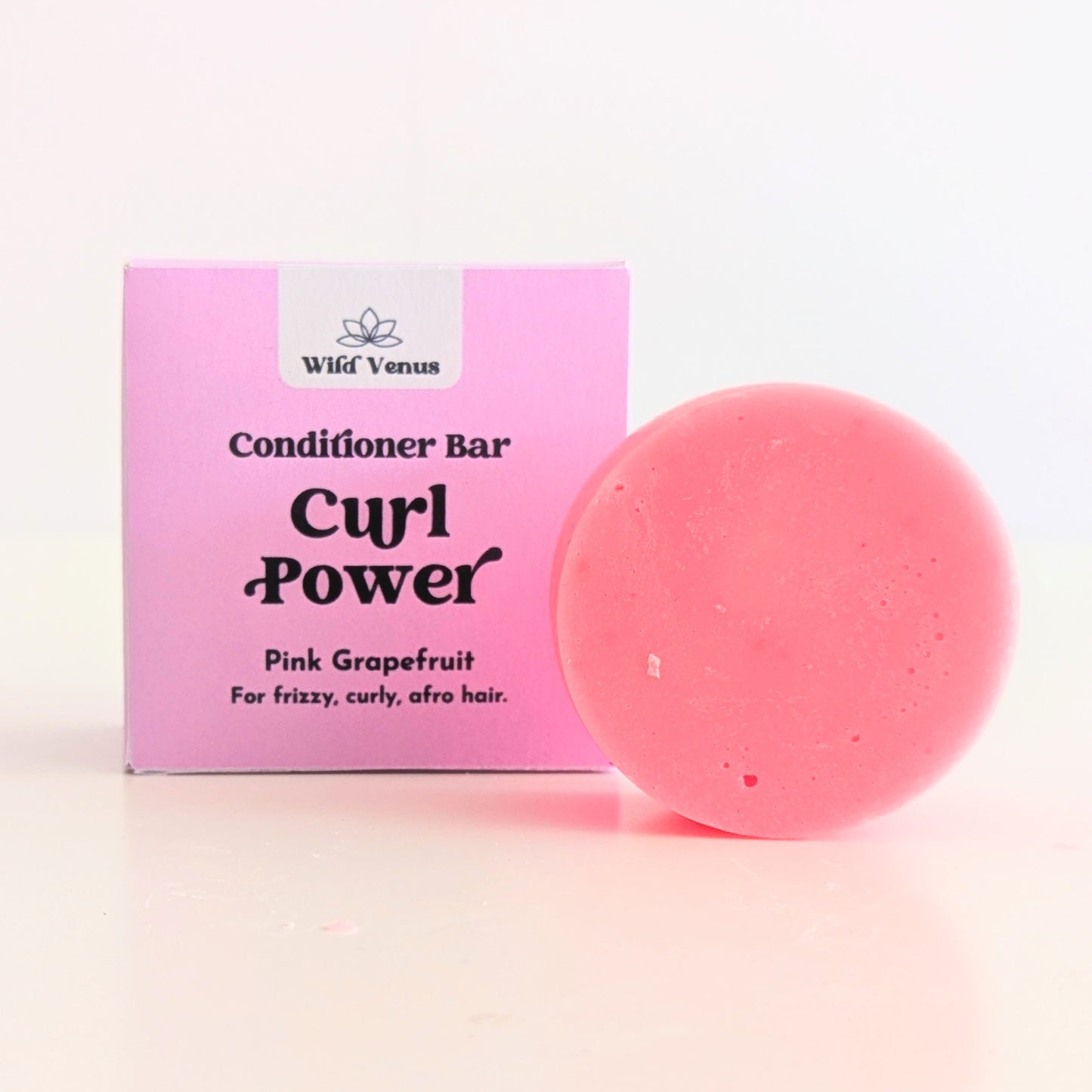 A Curl Power solid conditioner bar with pink grapefruit is in front of the box.