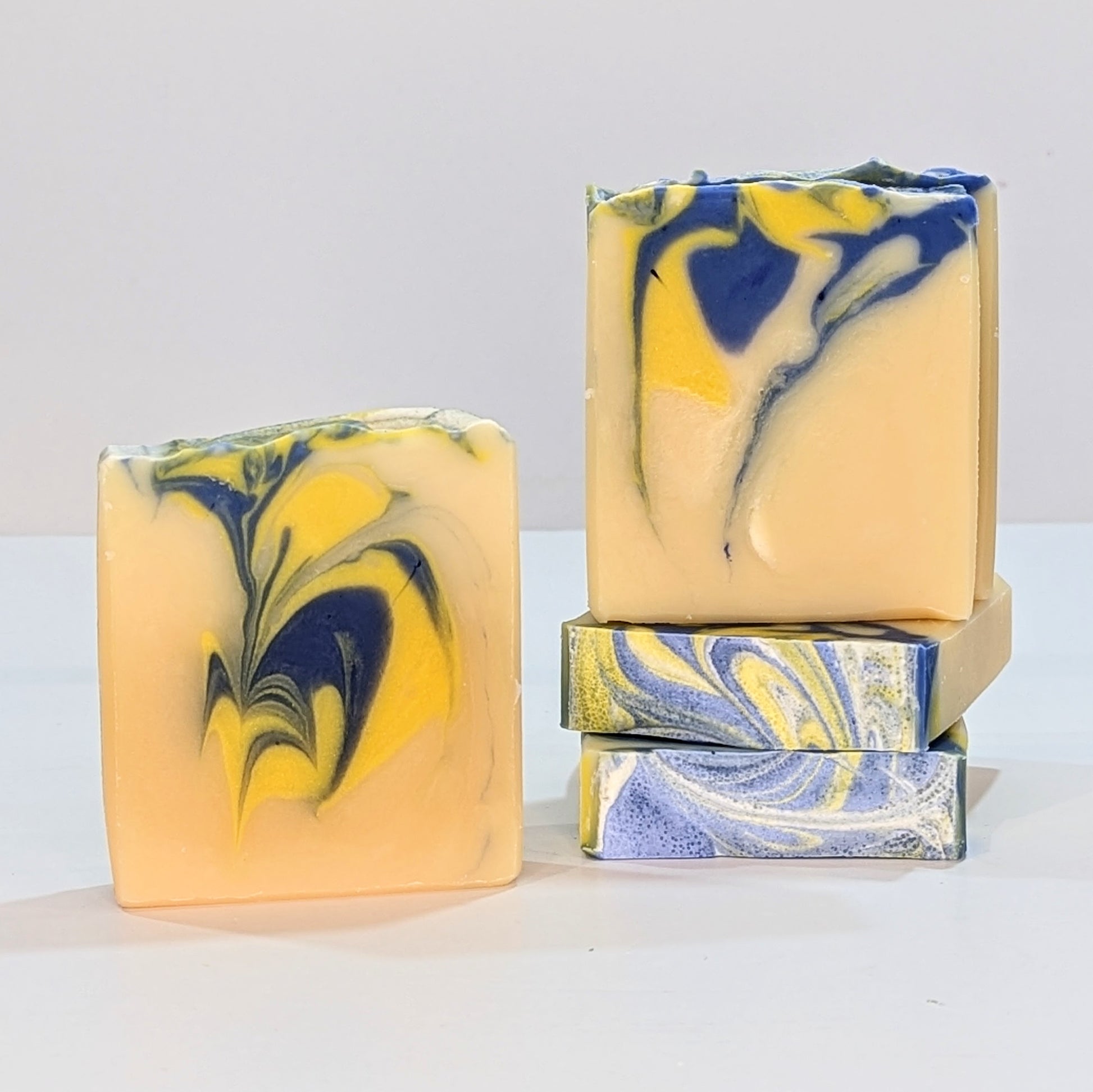 Lemon and lemongrass natural soaps stacked on top of each other.
