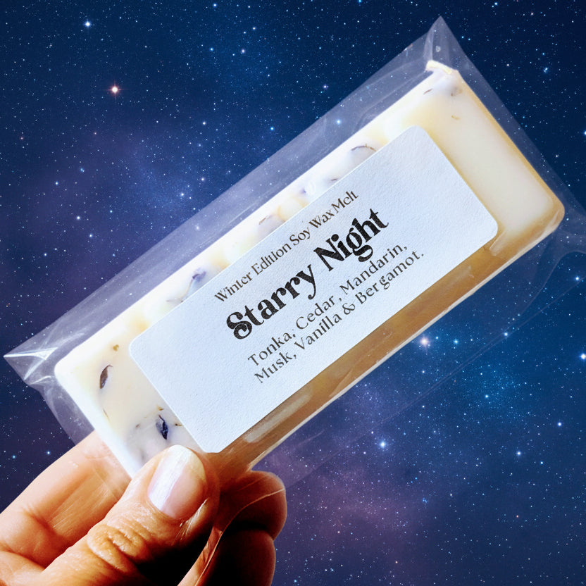 Holding the starry night soy wax melt against a starry night sky.