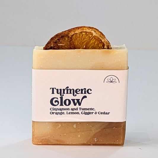 A bar of handmade Turmeric Glow vegan soap with orange, lemon, cedar wood and ginger essential oils. 