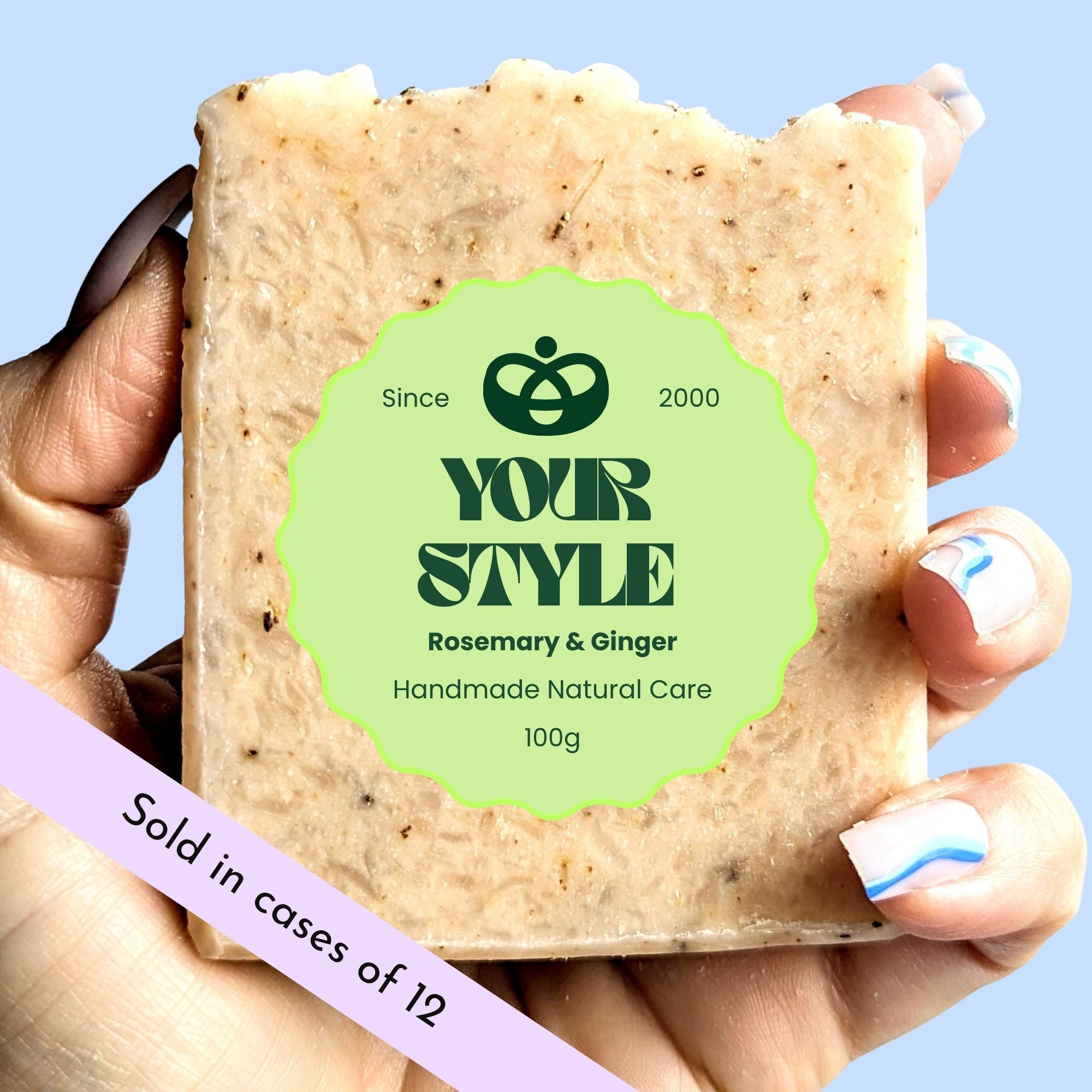 Handmade natural care soap bar with 'Your Style' branding held by a hand against a light blue background.