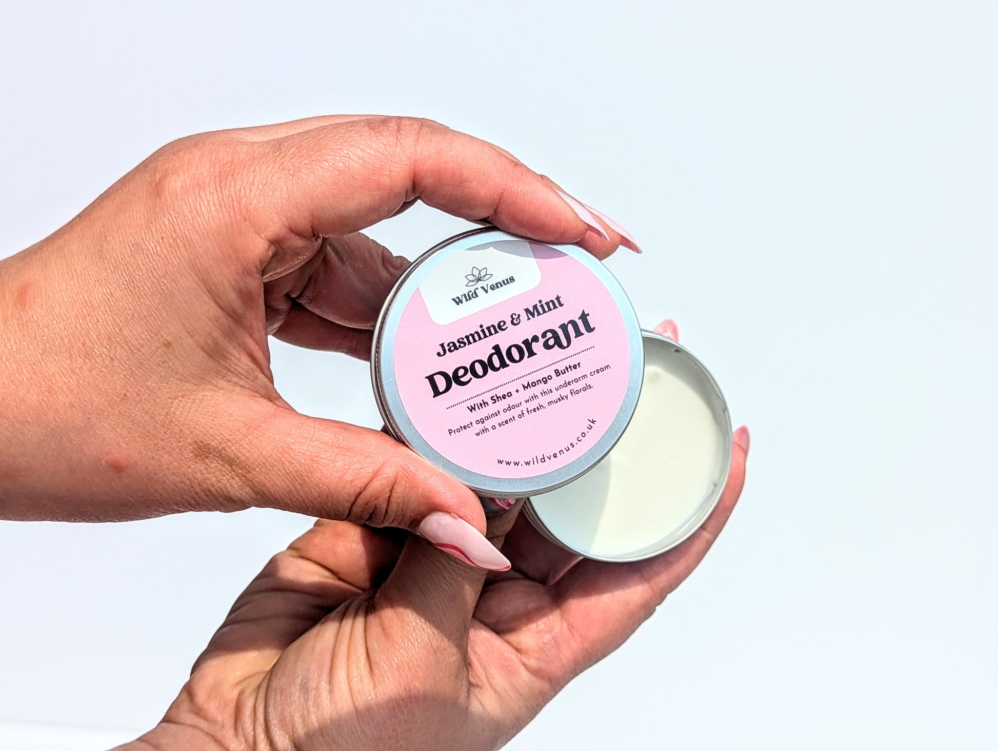 Holding an open Jasmine and Mint Deodorant