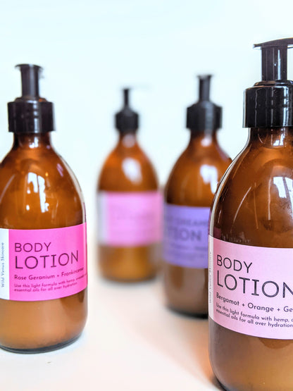 4 different body lotions all with pink and purple labels. 