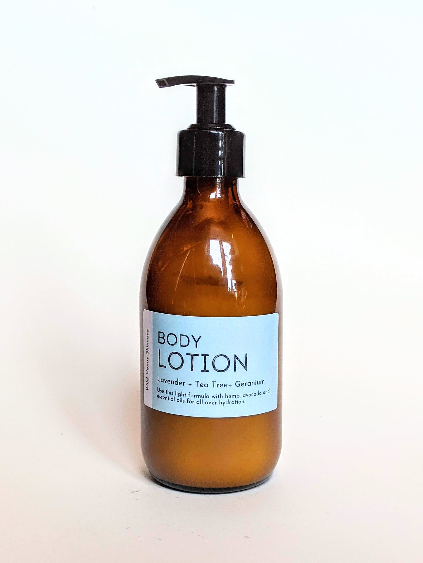 An amber bottle of lavender, tea tree and geranium hand and body lotion. 