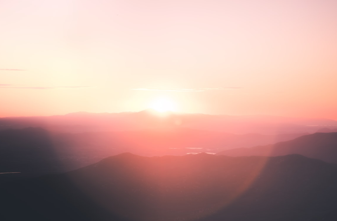 Poster for  Soy Wax Melt which is a dupe of Cerutti 1881. The picture shows some hills drenched in pink light. 