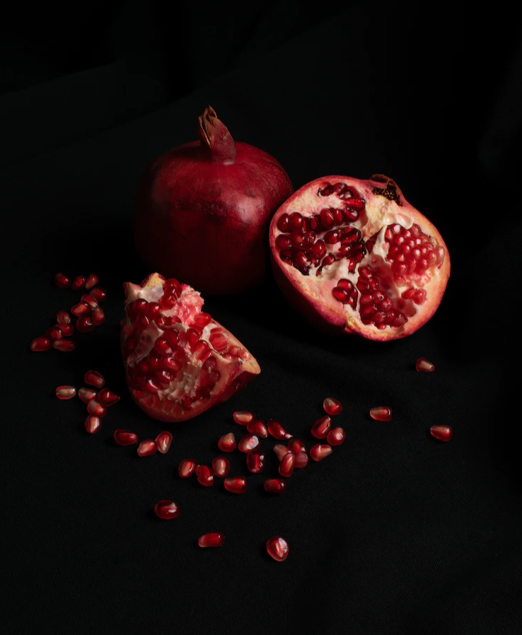 Pomegranates against a black background.